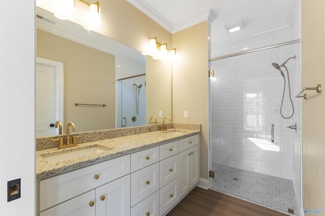full bathroom featuring visible vents, ornamental molding, a shower stall, and a sink