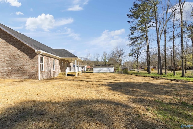 view of yard featuring an outbuilding and a shed