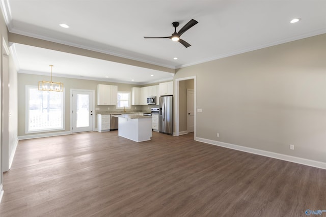 unfurnished living room with recessed lighting, baseboards, dark wood-type flooring, and ceiling fan with notable chandelier