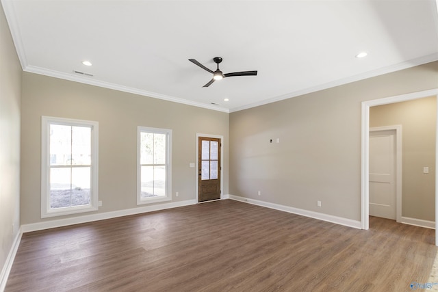 empty room with visible vents, baseboards, crown molding, and ceiling fan
