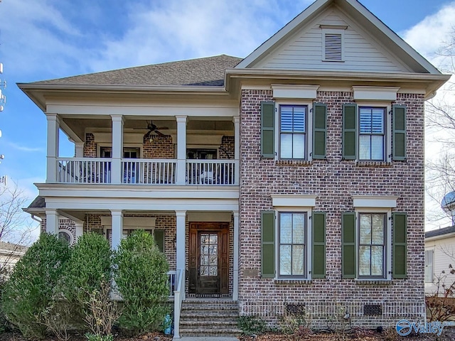 view of front of home with brick siding, a shingled roof, a balcony, and a ceiling fan