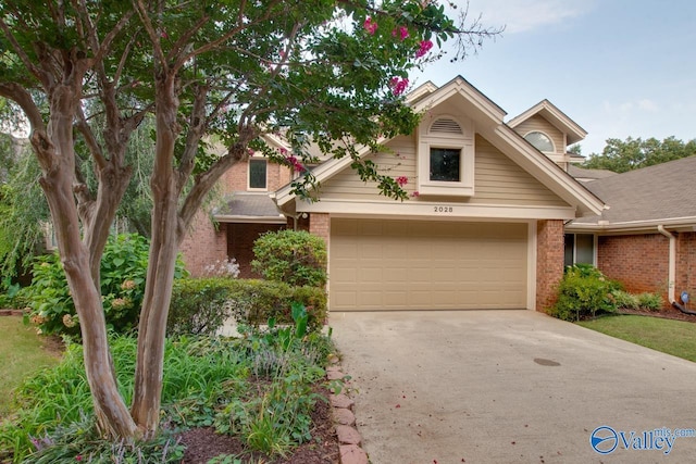 view of front of property with a garage, concrete driveway, and brick siding