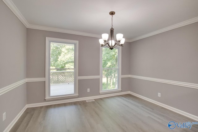 unfurnished dining area featuring light wood-style floors, a chandelier, visible vents, and baseboards