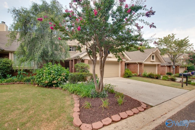 view of front facade with concrete driveway, brick siding, and a front yard