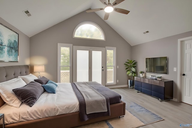 bedroom with high vaulted ceiling, access to outside, visible vents, and light wood-style flooring