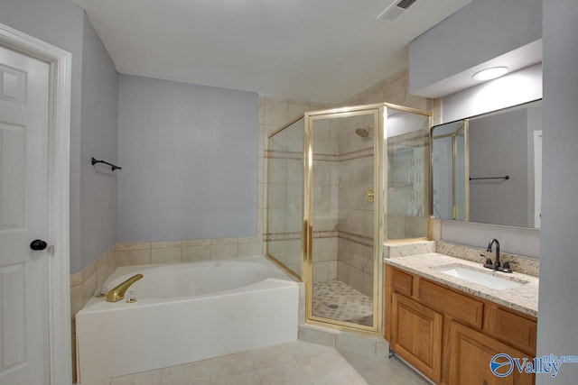 bathroom with visible vents, a stall shower, vanity, tile patterned flooring, and a bath