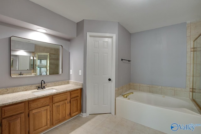 full bath featuring vanity, a bath, and tile patterned floors