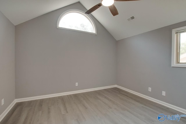 empty room with light wood-type flooring, plenty of natural light, visible vents, and baseboards