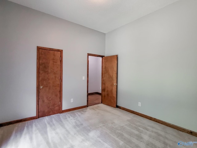 unfurnished bedroom with light carpet