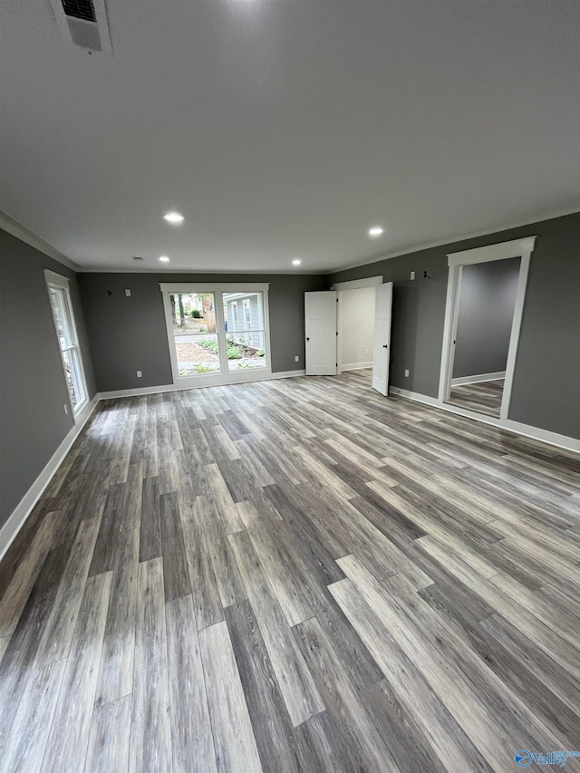 interior space featuring ornamental molding and hardwood / wood-style floors