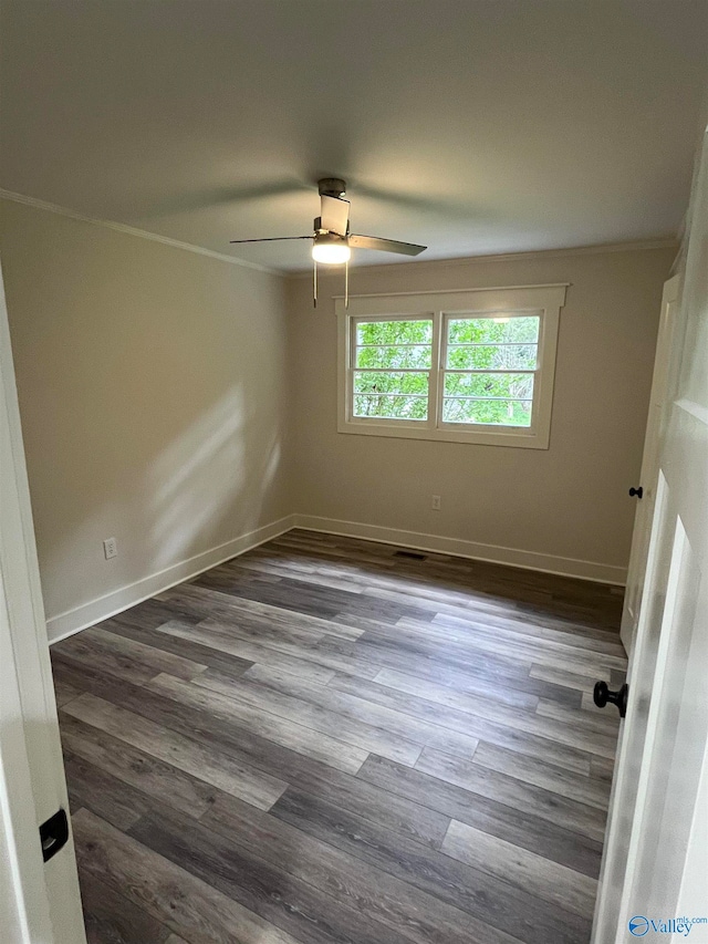 spare room featuring ceiling fan, crown molding, and dark hardwood / wood-style flooring