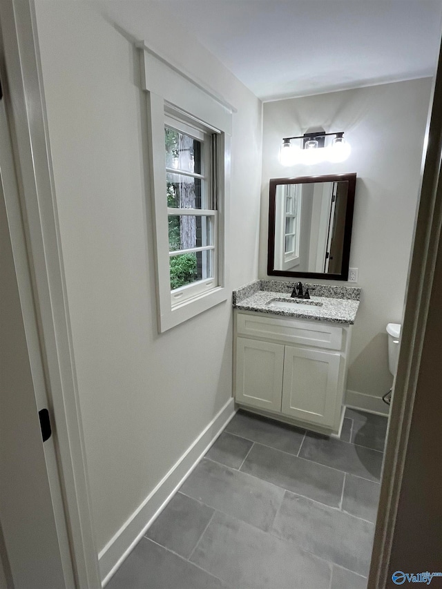 bathroom featuring vanity and toilet