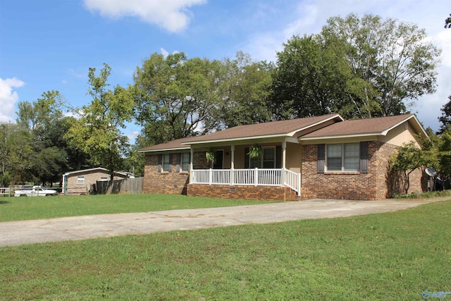 ranch-style home featuring a porch and a front lawn