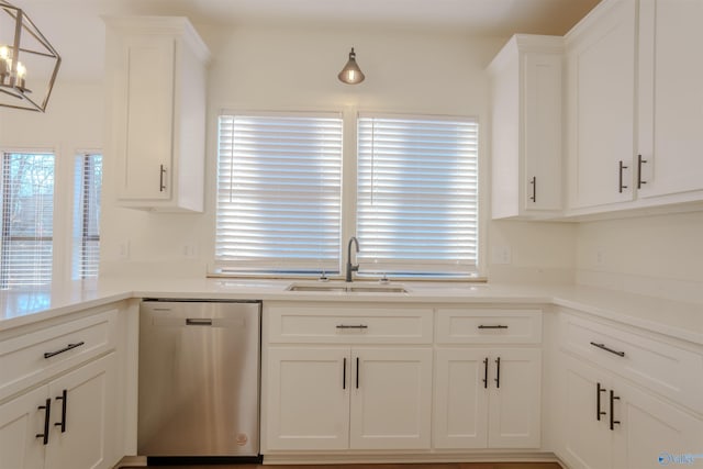 kitchen featuring dishwasher, a sink, white cabinetry, and a healthy amount of sunlight