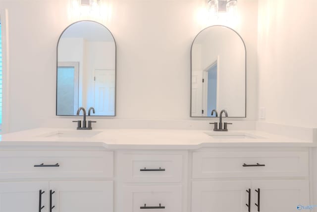 full bath with double vanity and a sink