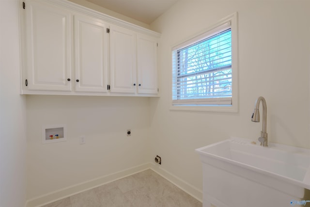 laundry area featuring cabinet space, baseboards, a sink, hookup for a washing machine, and electric dryer hookup