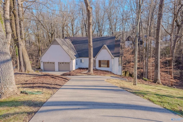 view of front of property with a detached garage and stucco siding