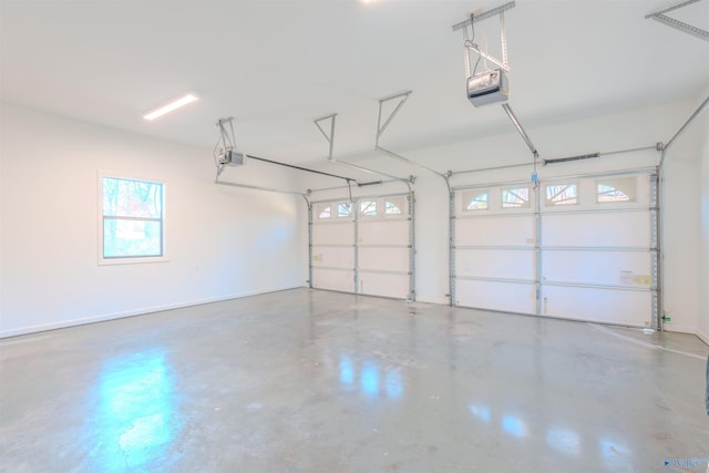 garage with baseboards and a garage door opener