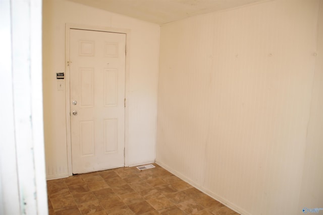 unfurnished room featuring visible vents