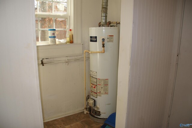 utility room featuring gas water heater
