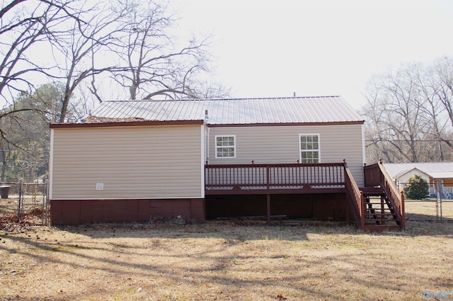 back of house with stairway, metal roof, a deck, and fence