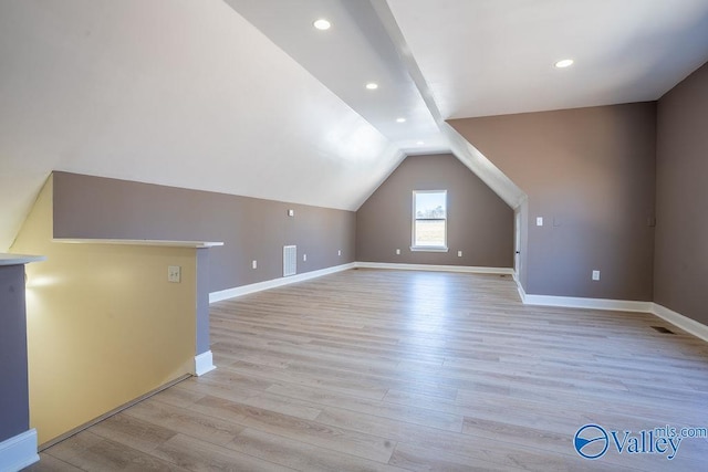bonus room with light wood-style floors, baseboards, vaulted ceiling, and recessed lighting
