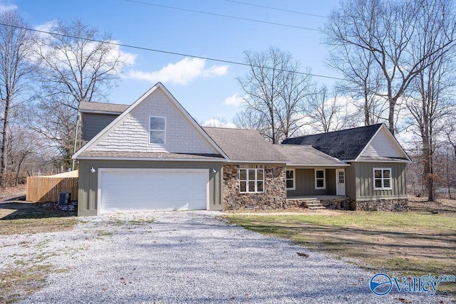 view of front facade with an attached garage, board and batten siding, central AC, stone siding, and driveway