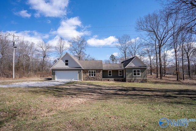 view of front facade featuring a garage, stone siding, driveway, and a front lawn