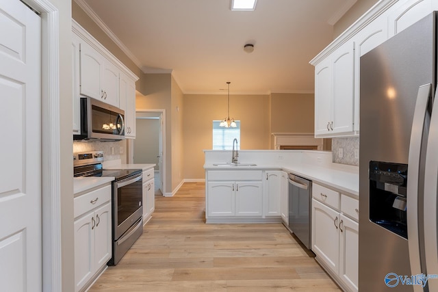 kitchen featuring stainless steel appliances, light hardwood / wood-style floors, white cabinetry, sink, and kitchen peninsula