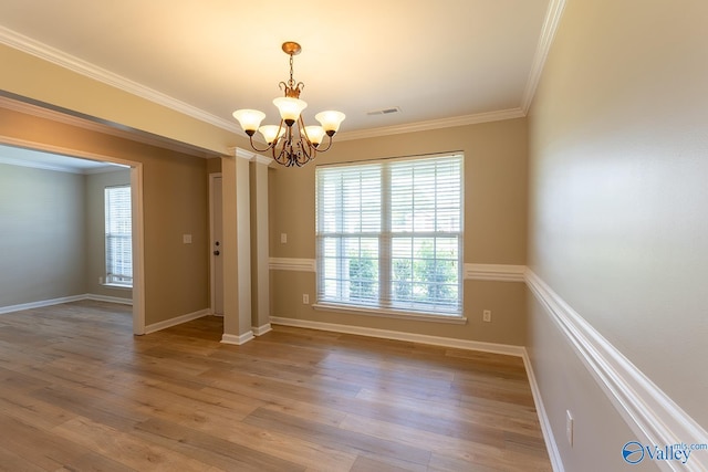 interior space featuring crown molding, a notable chandelier, and hardwood / wood-style floors