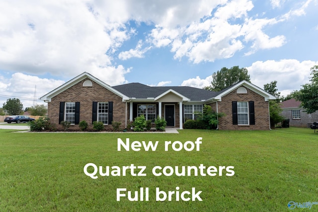 ranch-style home featuring brick siding and a front lawn