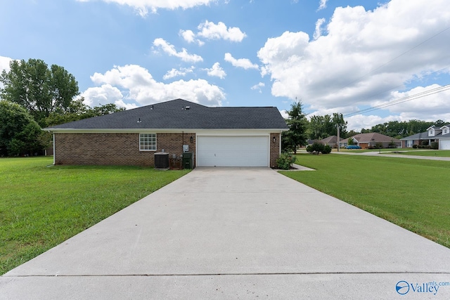 view of front of home with a front lawn, a garage, and central air condition unit