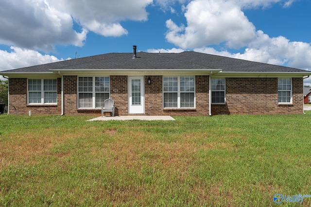 back of property featuring a lawn and a patio area