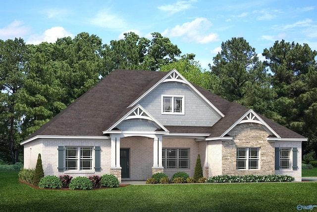 view of front facade featuring a front yard, stone siding, brick siding, and roof with shingles