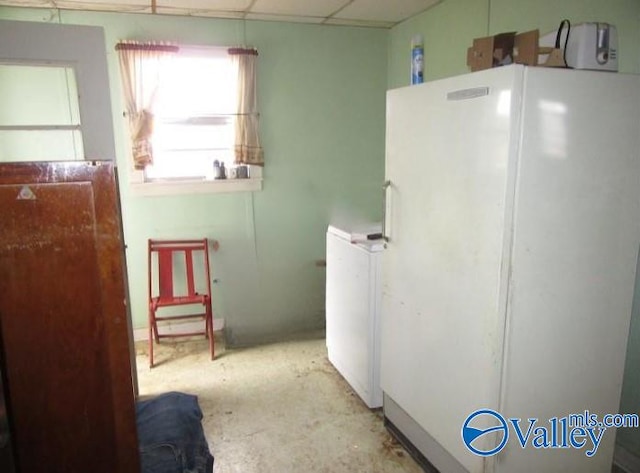 kitchen with white fridge and a paneled ceiling