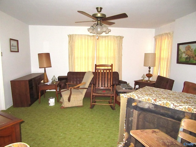 carpeted living room with ceiling fan