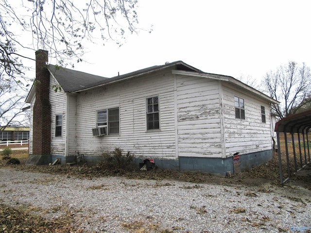 view of home's exterior with a carport and cooling unit