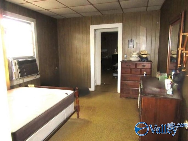 bedroom featuring wood walls, carpet flooring, a paneled ceiling, and cooling unit