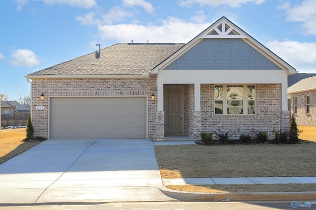 view of front of house featuring concrete driveway, brick siding, an attached garage, and roof with shingles