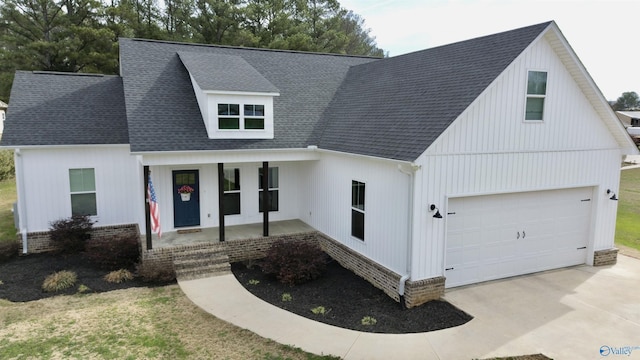 modern inspired farmhouse featuring a porch and a garage