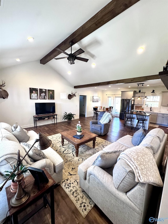 living room with beam ceiling, ceiling fan, dark hardwood / wood-style flooring, and high vaulted ceiling