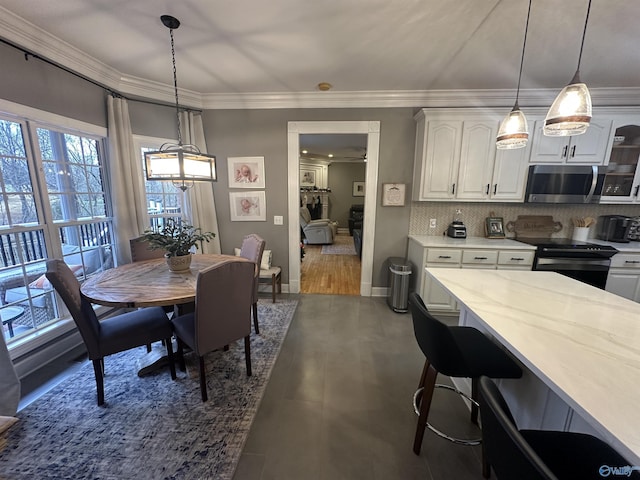 dining space featuring crown molding