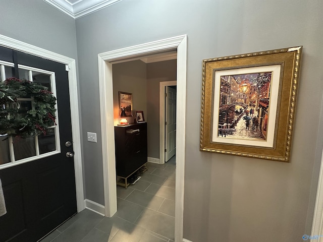 hall with tile patterned floors and ornamental molding