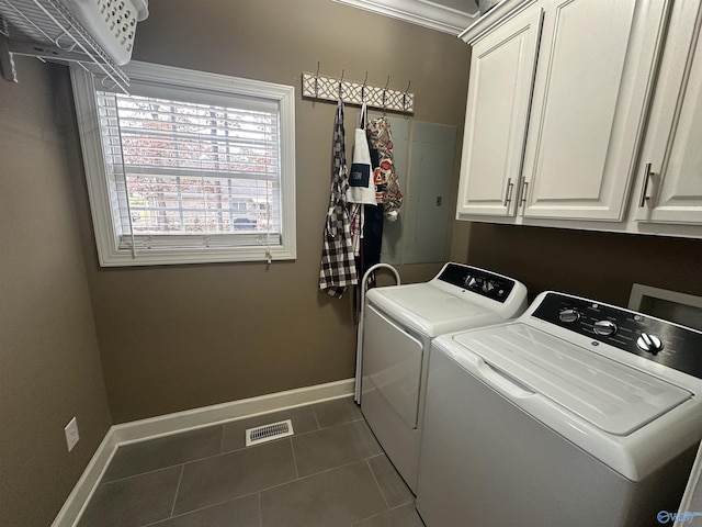 laundry room featuring cabinets, washing machine and dryer, and dark tile patterned flooring