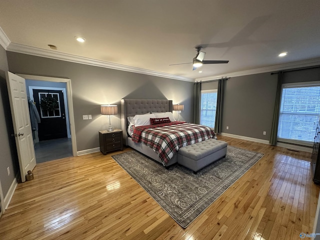 bedroom featuring multiple windows, ceiling fan, and light hardwood / wood-style flooring