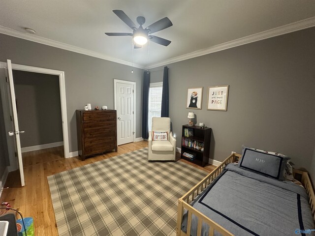 bedroom featuring ceiling fan, ornamental molding, and hardwood / wood-style flooring