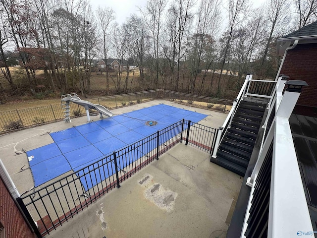 view of swimming pool with a water slide