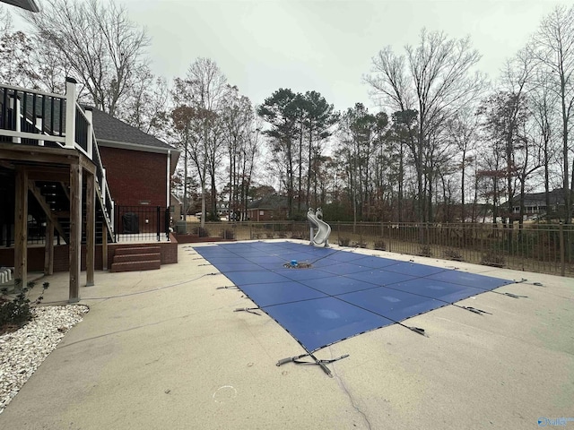 view of swimming pool featuring a patio area and a water slide