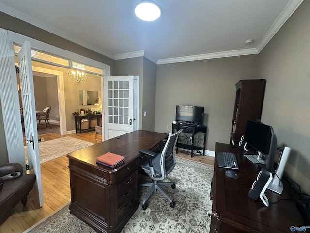 office featuring light hardwood / wood-style flooring, ornamental molding, french doors, and a notable chandelier