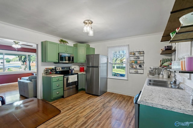 kitchen featuring a wealth of natural light, sink, appliances with stainless steel finishes, and light hardwood / wood-style flooring